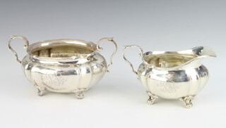 A Sterling silver sugar bowl and cream jug on scroll feet 215 grams 
