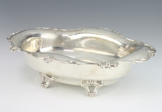A Sterling silver bowl on scroll feet with floral rim and engraved monogram 29cm, 520 grams