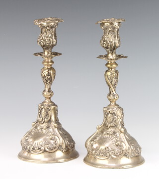 A pair of Portuguese repousse silver candlesticks 590 grams, 26cm 