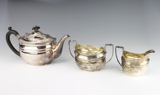 A 1930's silver melon shaped teapot, sugar bowl and milk jug with ebony mounts, London 1932, C S Harris & Sons Ltd 880 grams gross 