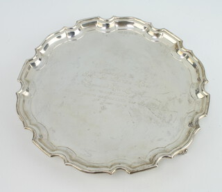 A silver salver with Chippendale rim and engraved inscription, on scroll feet, Birmingham 1973, Deakin & Francis 310 grams, 25cm 