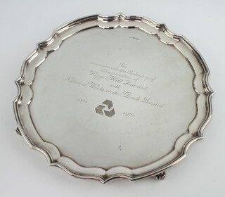 A silver salver with Chippendale rim and presentation inscription, on scroll feet, Sheffield 1977, 30cm, 790 grams 