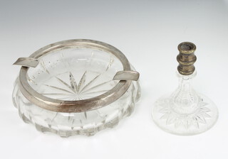 A circular cut glass ashtray with 800 standard mount 18cm together with a mounted candlestick 12cm 