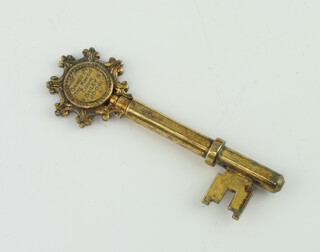 A silver gilt presentation key with engraved presentation inscription, 24 grams