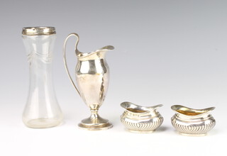 A silver urn shaped cream jug London 1922, a pair of salts and a silver rimmed vase 170 grams