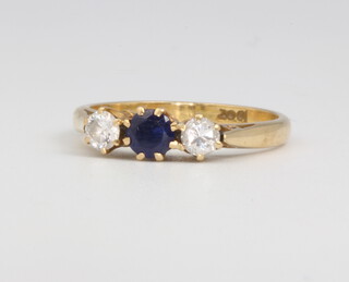 An 18ct yellow gold sapphire and diamond ring, the centre sapphire approx. 0.2ct flanked by diamonds approx 0.3ct, size L, 2.8 grams 