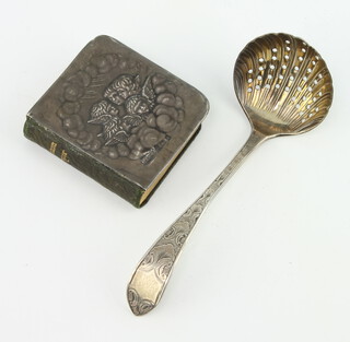 An Edwardian silver mounted Book of Common Prayer with Reynolds Angels decoration and a silver sifter spoon