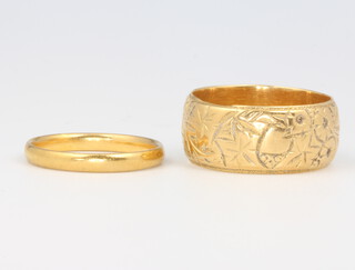 An 18ct yellow gold wedding band size O, 10 grams and a 22ct gold ditto size K, 2 grams 