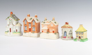 A Victorian Staffordshire money bank in the form of a thatched cottage 9cm, ditto hexagonal cottage 9cm, Victorian house 13cm, ditto 14cm and 1 other 11cm 
