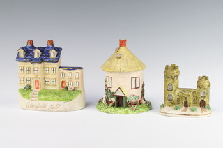 A Victorian Staffordshire castle 10cm, a ditto house 14cm and a circular thatched cottage with removable roof 14cm 
