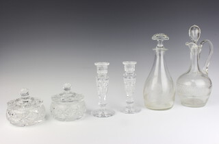 An etched glass club shaped decanter and stopper 24cm, a cut glass ewer and stopper 27cm (chips to stopper) together with a cut glass 4 piece dressing table set (2 jars with chips to the inside) 