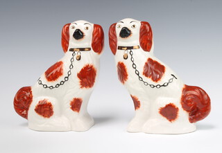 A pair of Victorian Staffordshire Spaniels with ochre decoration 22cm  