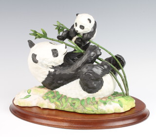 A Franklin Mint group of pandas - Pride and Joy 19cm, on a wooden stand