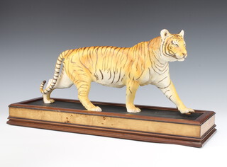 A Franklin Mint figure of a tiger - On The Prowl on a wooden stand 53cm 