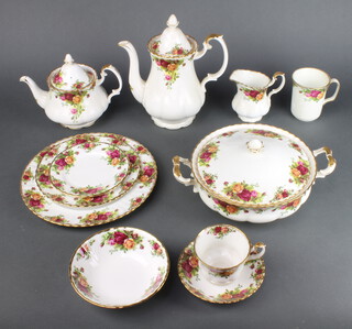 A Royal Albert Old Country Roses tea, coffee and dinner service comprising 7 small tea cups (1 a/f), 6 saucers, 9 large tea cups (2 a/f), 6 saucers (1 a/f), 4 coffee cups, tea pot, coffee pot, milk jug, sugar bowl, 10 small plates, 7 medium plates, 6 dinner plates, sandwich plate, meat plate, 7 dessert bowls, salad bowl, 2 tureens and covers, salt and pepper, 2 swan pots, butter dish and cover, sauce boat and stand, rectangular dish, 3 tier cake stand, wall timepiece, timepiece, 12 place mats, 6 cork wine coasters and 3 similar butter dishes 