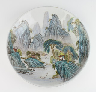 A Chinese shallow dish decorated with figures in boats with extensive mountain range and buildings, with  character mark to the base 32cm 