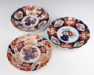 A pair of Japanese scalloped dishes decorated with flowers 22cm and ditto 21cm 