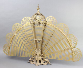 A Victorian style pierced brass peacock spark guard 62cm x 86cm 