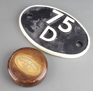 A Southern Railways oval brass engineers badge mounted as a paperweight and contained in a mahogany base 2cm x 8cm together with a British Railways Southern Loco wagon? plaque marked 75D 11cm x 18cm 