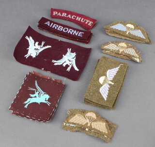 Six Second World War Parachute Regiment shoulder flashes, 2 ditto cloth shoulder titles, 4 cloth airborne shoulder flashes and 13 parachutists wings 