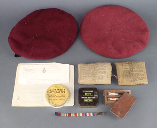 A Second World War Royal Artillery parachutists beret with name tag Skaife D'Ingerthorpe (some moth) together with 1 other dated 1942 (no badge), a War Office Medical Division first field dressing, 1 other field dressing dated 1940, tin of sterilising outfit for use with water bottle in a metal case, tin of ointment "antigas no.2" and 2 tubes of Solution of Morphine Tartrate  