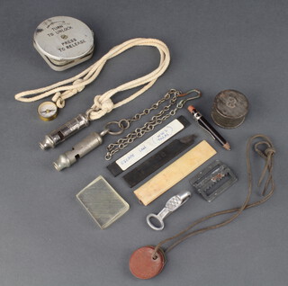 Three Second World War parachutists escape saws, a parachute buckle release, scout whistle, section of perspex, Metropolitan Patent police whistle, lanyard compass and 2 sets of dog tags to 1081726 Skaife JD and 212920 Skaife JD 