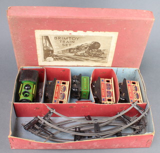 A Wells of London Brimtoy train set comprising clockwork locomotive tender, 3 carriages and a small section of rails, boxed 