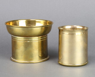 A circular Trench Art vase formed from the cooling pipe of a Spitfire Mk 5 and made at the No.7 School of Technical Training 8cm h x 6.5cm diam., a WWI Trench Art vase formed from a brass shell case 8cm h x 9cm diam. base marked AC&C no.112M 