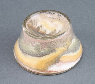 A Victorian Alum Bay glass paperweight of waisted form decorated The Needles 5cm x 8cm, the base with paper label Isle of Wight Curiosity, arranged with genuine sand from the famous coloured cliffs of Alum Bay 