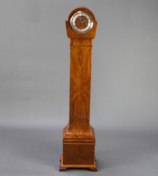 An Enfield Art Deco 8 day striking "granddaughter clock" with silvered chapter ring and Roman numerals, contained in a shaped quarter veneered walnut case 144cm h 