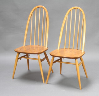 Ercol, a pair of light elm stick and rail back dining chairs, raised on turned supports with H framed stretcher, the base marked BSBH 1960