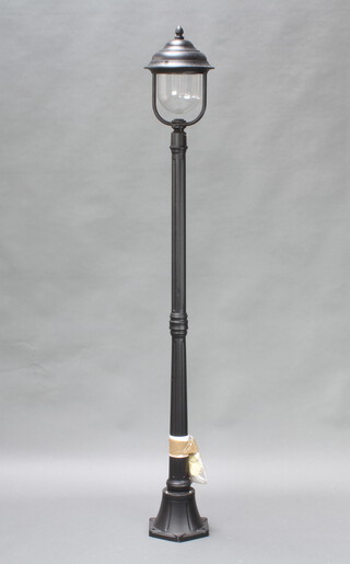 A black painted metal garden lamp in the form of a street lamp on a fluted column 176cm h x  22cm w 