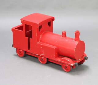 A child's red painted wooden model locomotive 39cm h x 72cm w x 25cm d 
