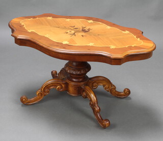 A shaped inlaid mahogany coffee table raised on turned column and tripod base 54cm h x 101cm w x 61cm d 
