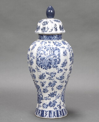 A Chinese style blue and white pottery urn and cover 50cm h x 21cm diam. 
