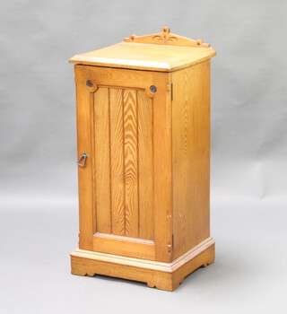 A Victorian pine pot cupboard with raised back and enclosed by a panelled door, raised on a platform base 82cm h x 38cm w x 35cm d 