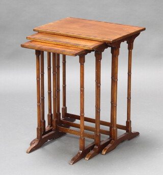 A nest of 3 Georgian style crossbanded mahogany coffee tables raised on turned supports 62cm h x 50cm w x 35cm d 