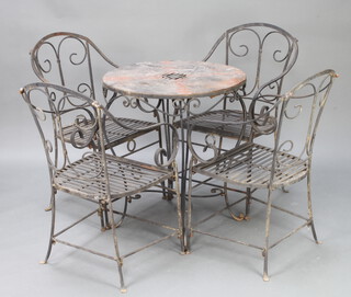 A wrought iron garden suite comprising circular table raised on cabriole supports 78cm h x 69cm diam. (top slightly rusted) together with 4 wrought iron open arm chairs 
