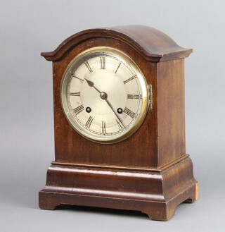 An Edwardian striking bracket clock with silvered dial and Roman numerals contained in an arch shaped mahogany case 