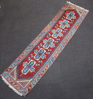 A red and blue ground Caucasian style runner with 6 cross shaped medallions to the centre 301cm x 76cm 