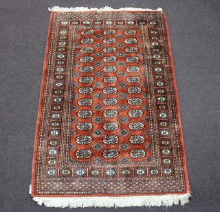 A brown and white ground Bokhara rug with 36 octagons to the centre 200cm x 120cm 