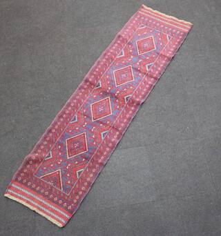 A red and blue ground Meshwani runner with 4 diamonds to the centre with a multi-row border 246cm x 66cm 