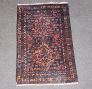 A red and blue ground Belouche rug within multi row border 134cm x 85cm 