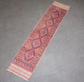 A red and blue ground Meshwani runner with 5 diamonds to the centre within a multi row border 251cm x 59cm 