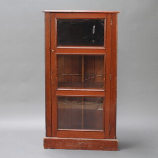 A 19th Century pine D shaped cabinet, fitted shelves enclosed by glazed panelled doors, raised on a platform base 134cm h x 71cm w x 36cm d 