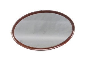 An Edwardian oval plate wall mirror contained in a mahogany frame 57cm h x 92cm w 
