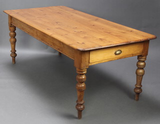 A Victorian pine kitchen table with planked top fitted 2 long drawers raised on turned supports 74cm h x 200cm l x 96cm w 