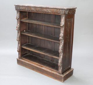 A Victorian carved oak bookcase fitted adjustable shelves raised on a platform base 113cm h x x 106cm w x 30cm d  
