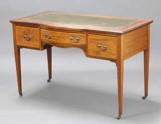 An Edwardian bow front inlaid mahogany writing table with green inset leather writing surface above 1 long and 2 short drawers, raised on square tapered supports 77cm h x 120cm w x 62cm d 