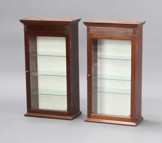 A pair of 19th Century mahogany display cabinets with moulded cornice, fitted shelves enclosed by bevelled glazed panelled doors 70cm h x 39cm w x 20cm d 
